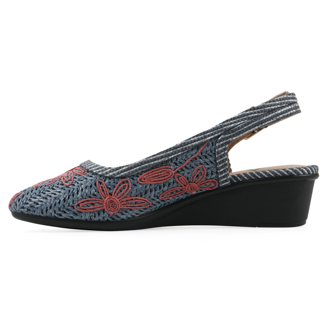 Side view of a woven, blue, raffia slingback with muted red floral detailing and an adjustable heel strap