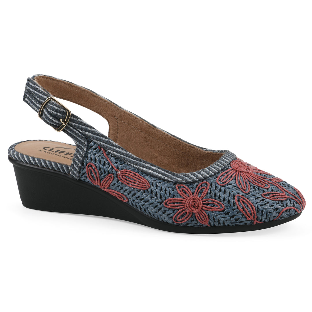 Angle view of a woven, blue, raffia slingback with muted red floral detailing and an adjustable heel strap