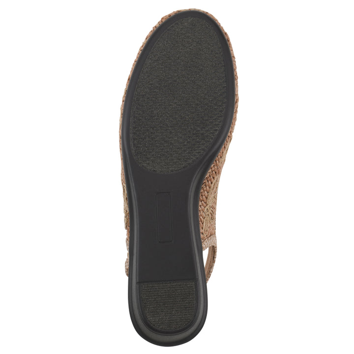 Sole view of a woven, cognac, raffia slingback with neutral floral detailing and an adjustable heel strap