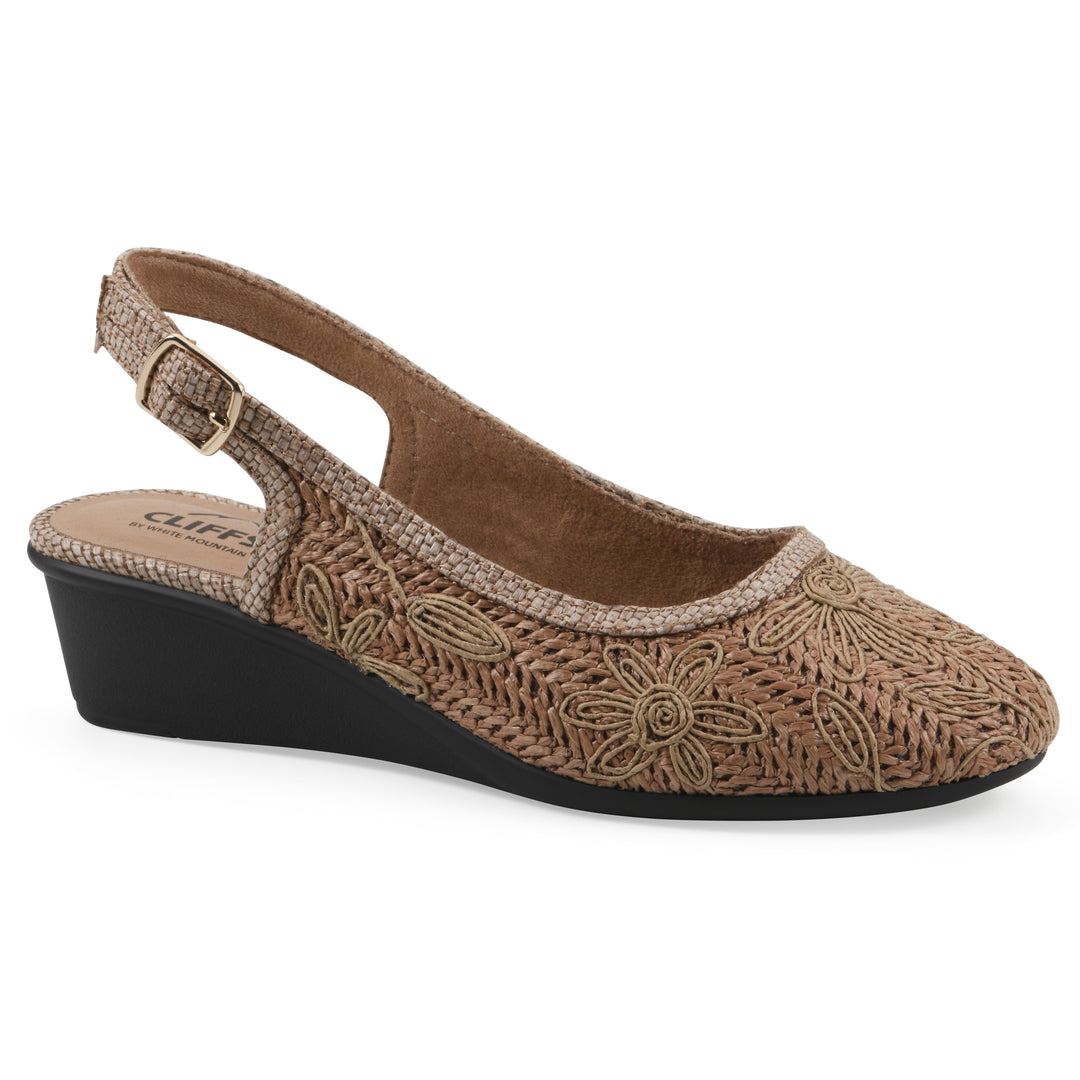 Angle view of a woven, cognac, raffia slingback with neutral floral detailing and an adjustable heel strap