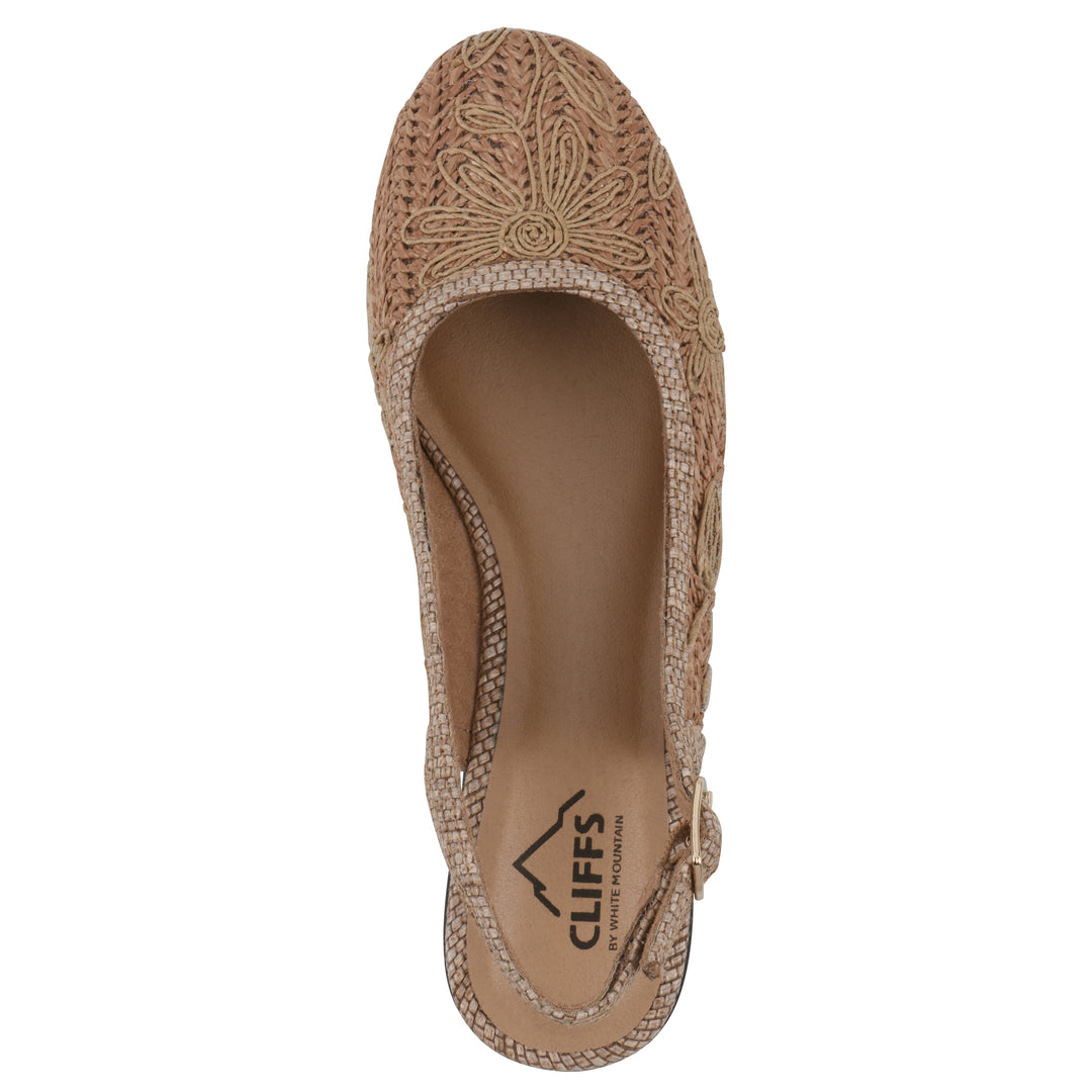 Top view of a woven, cognac, raffia slingback with neutral floral detailing and an adjustable heel strap
