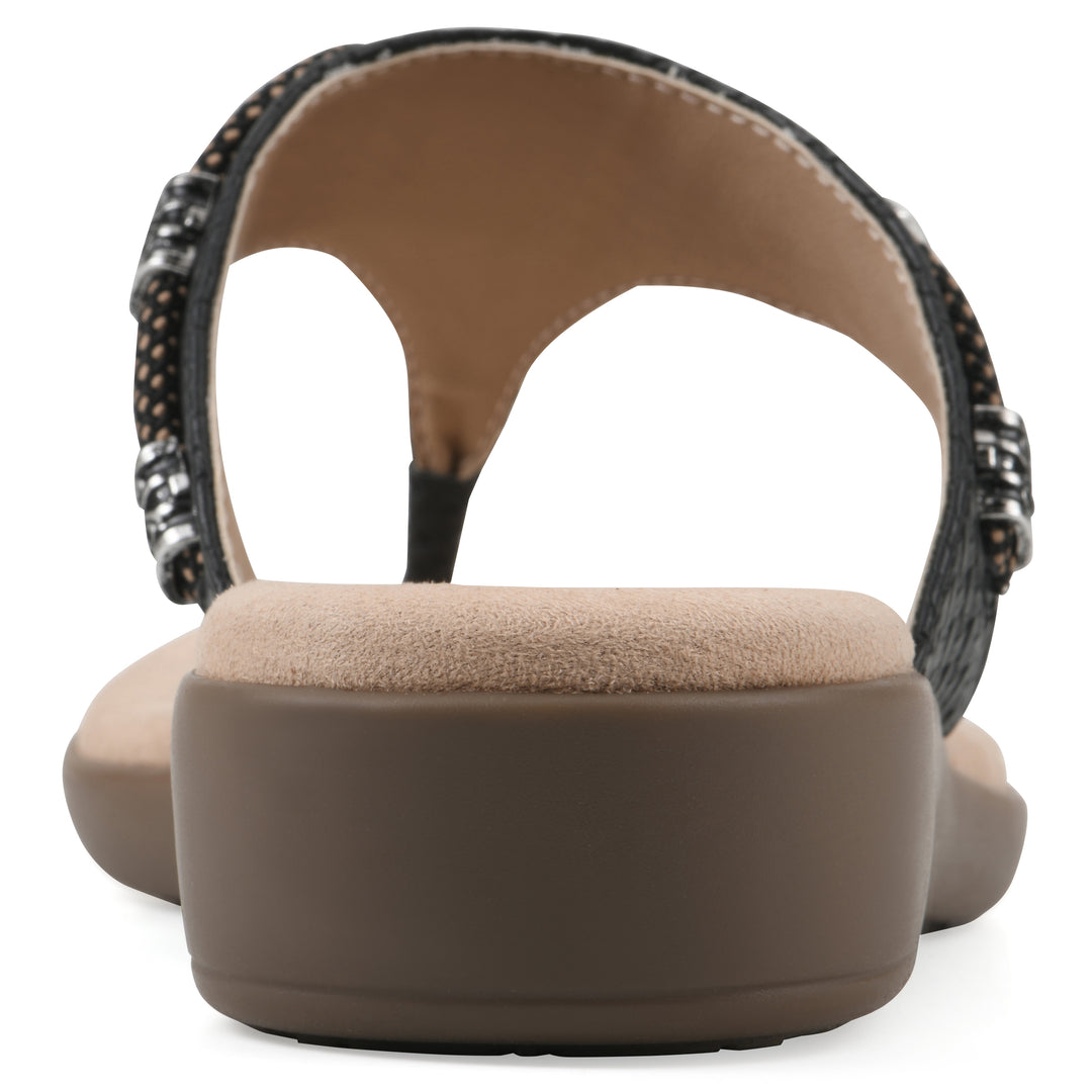 Rear view of black thong sandal with silver bead embellishments and a tan sole