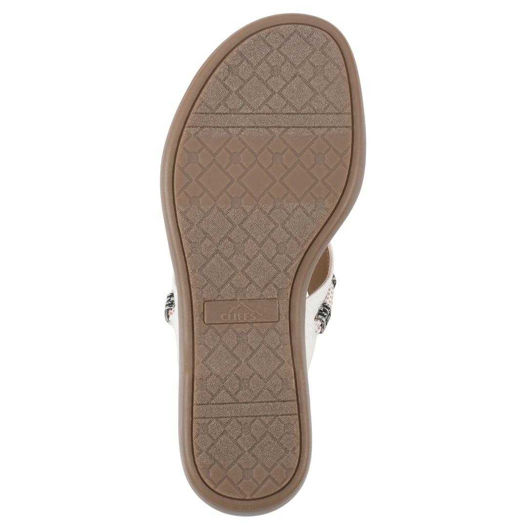 Sole view of white thong sandal with silver bead embellishments and a tan sole