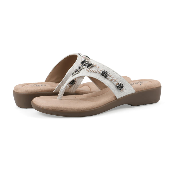 Angle view of a pair of white thong sandals with silver bead embellishments and a tan sole