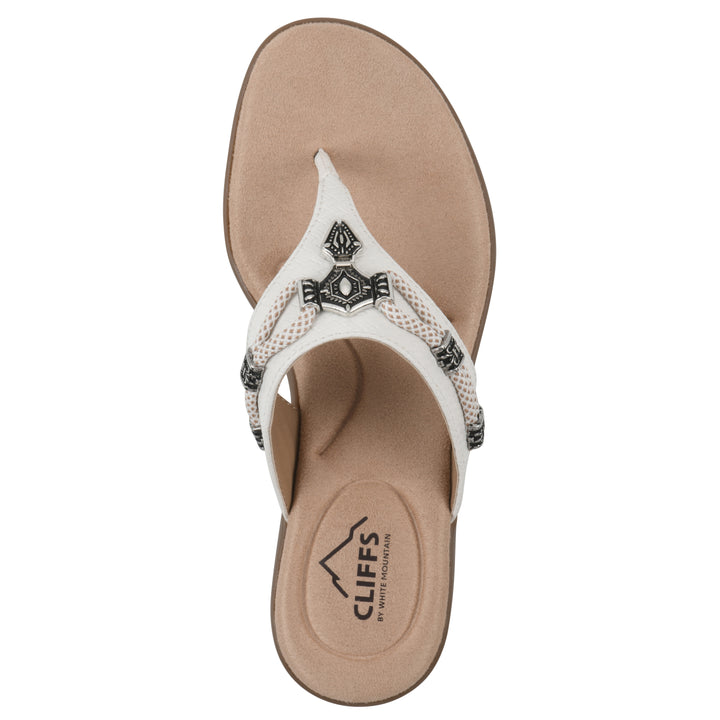 Top view of white thong sandal with silver bead embellishments and a tan sole