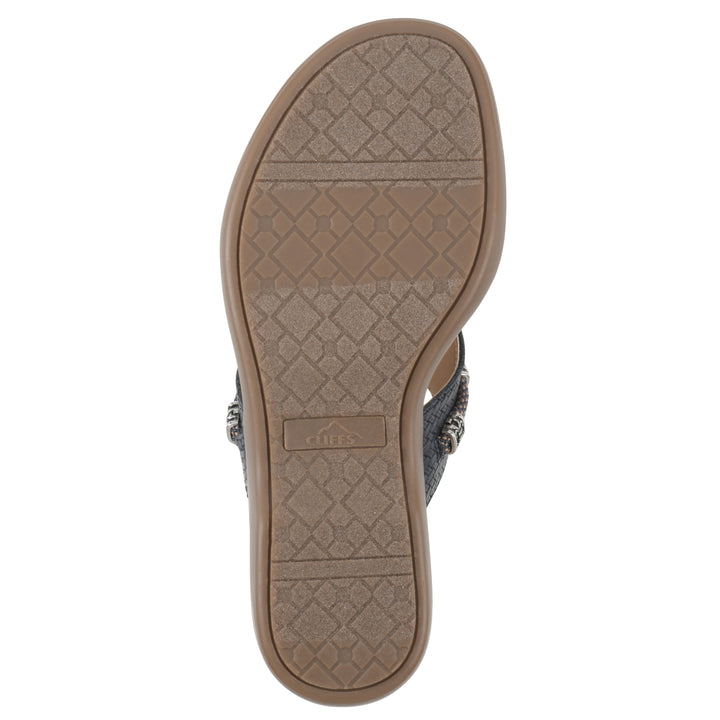 Sole view of navy thong sandal with silver bead embellishments and a tan sole