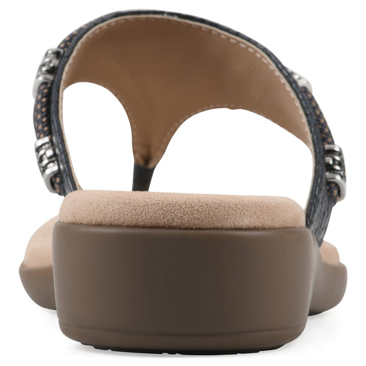 Rear view of navy thong sandal with silver bead embellishments and a tan sole