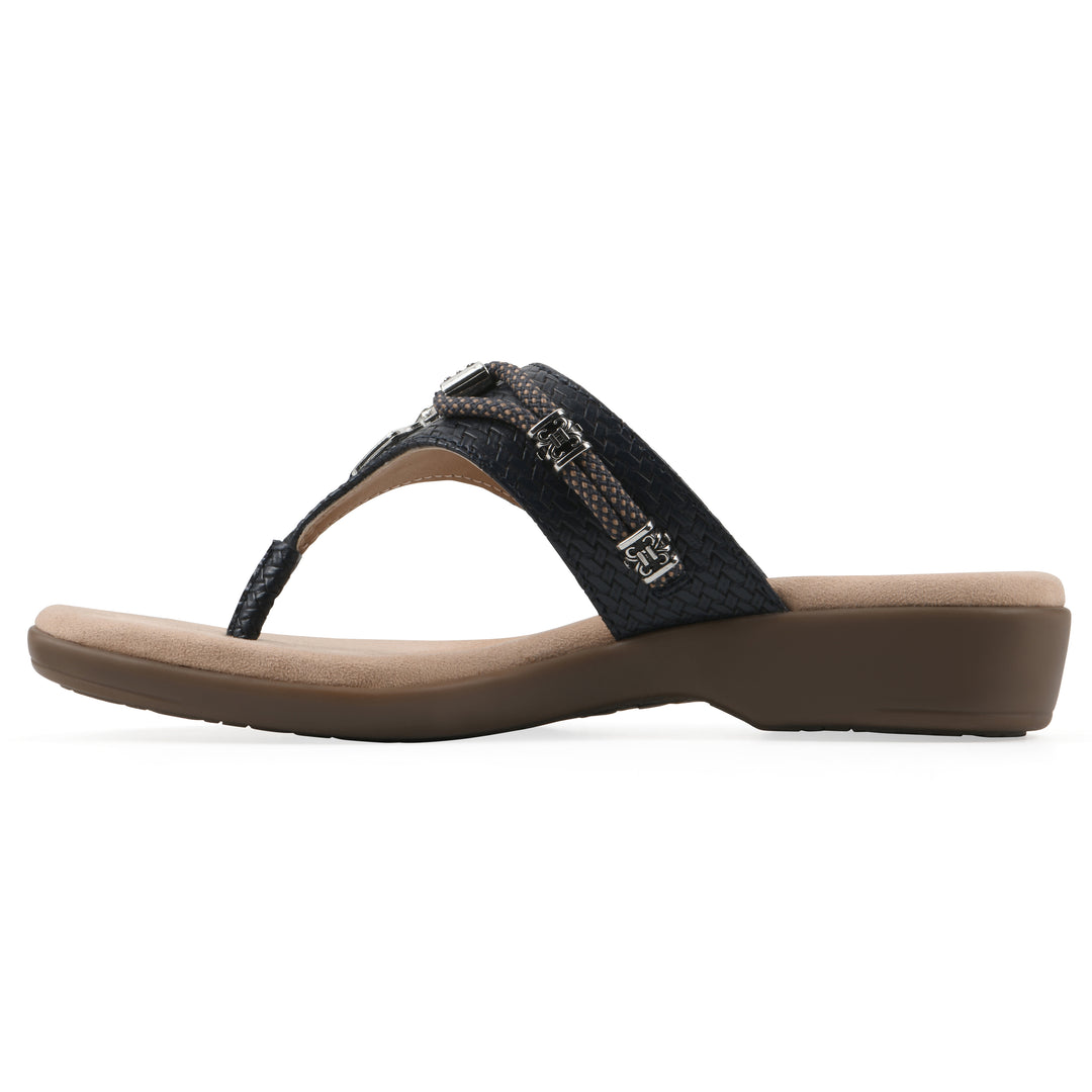 Side view of navy thong sandal with silver bead embellishments and a tan sole