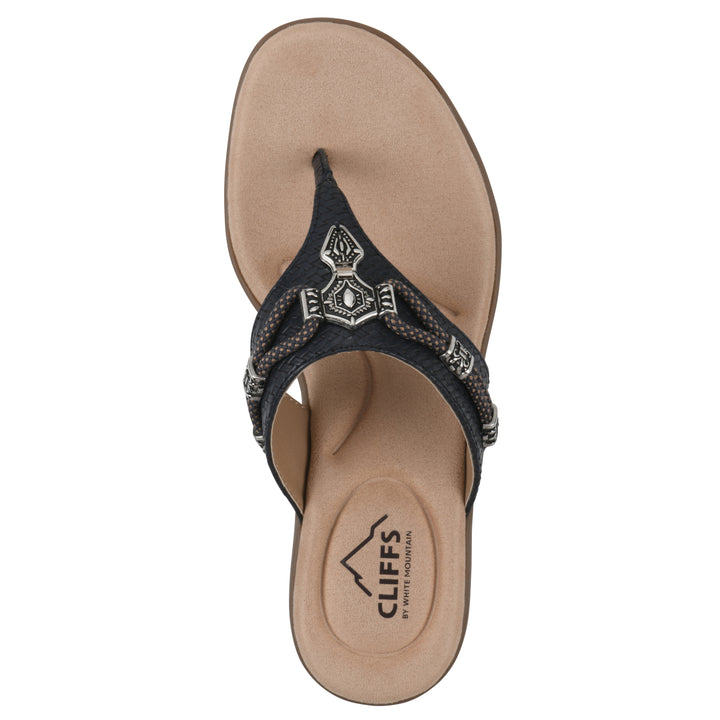 Top view of navy thong sandal with silver bead embellishments and a tan sole