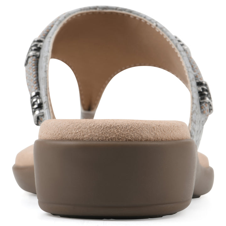 Rear view of a slate thong sandal with silver bead embellishments and a tan sole