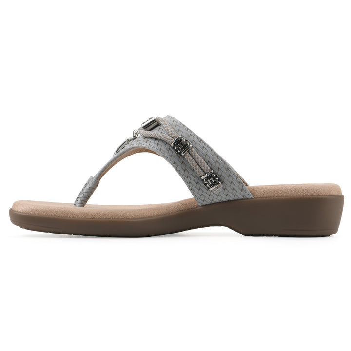 Side view of a slate thong sandal with silver bead embellishments and a tan sole