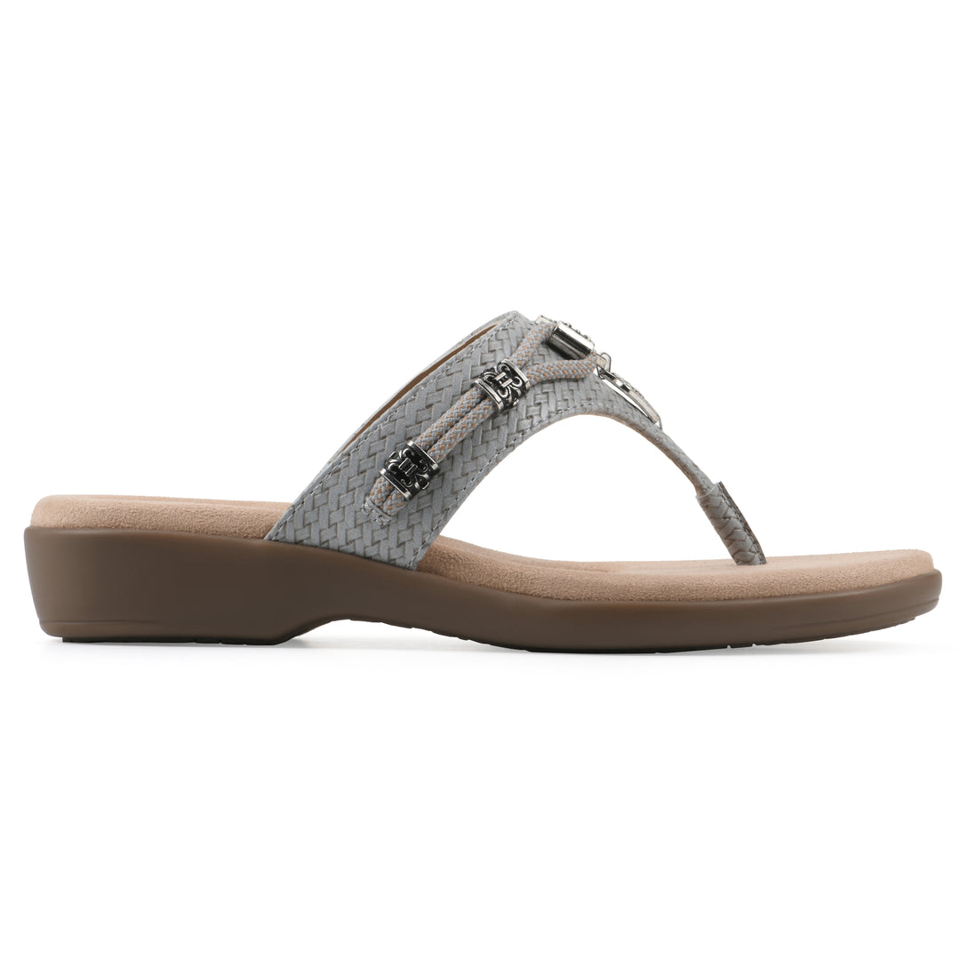 Side view of a slate thong sandal with silver bead embellishments and a tan sole