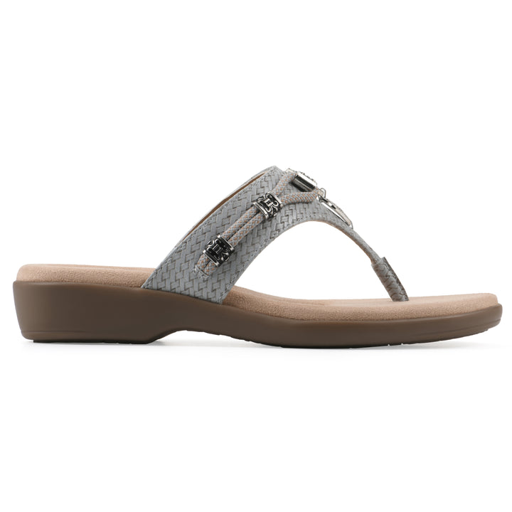 Side view of a slate thong sandal with silver bead embellishments and a tan sole