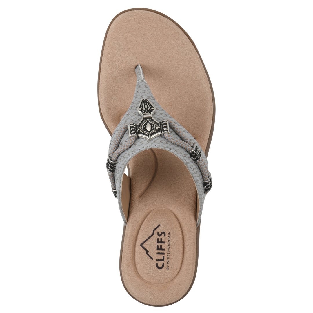 Top view of a slate thong sandal with silver bead embellishments and a tan sole