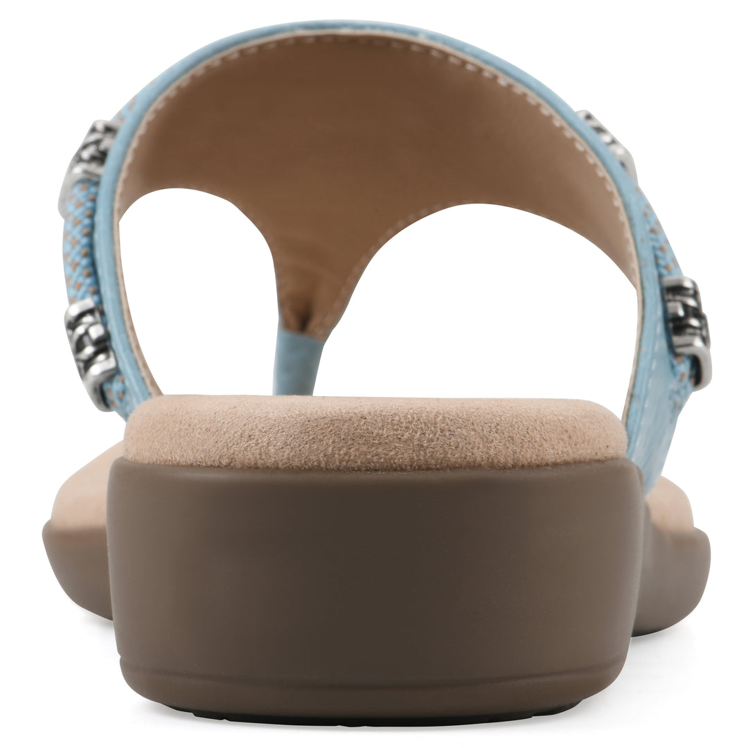 Rear view of light blue thong sandal with silver bead embellishments and a tan sole