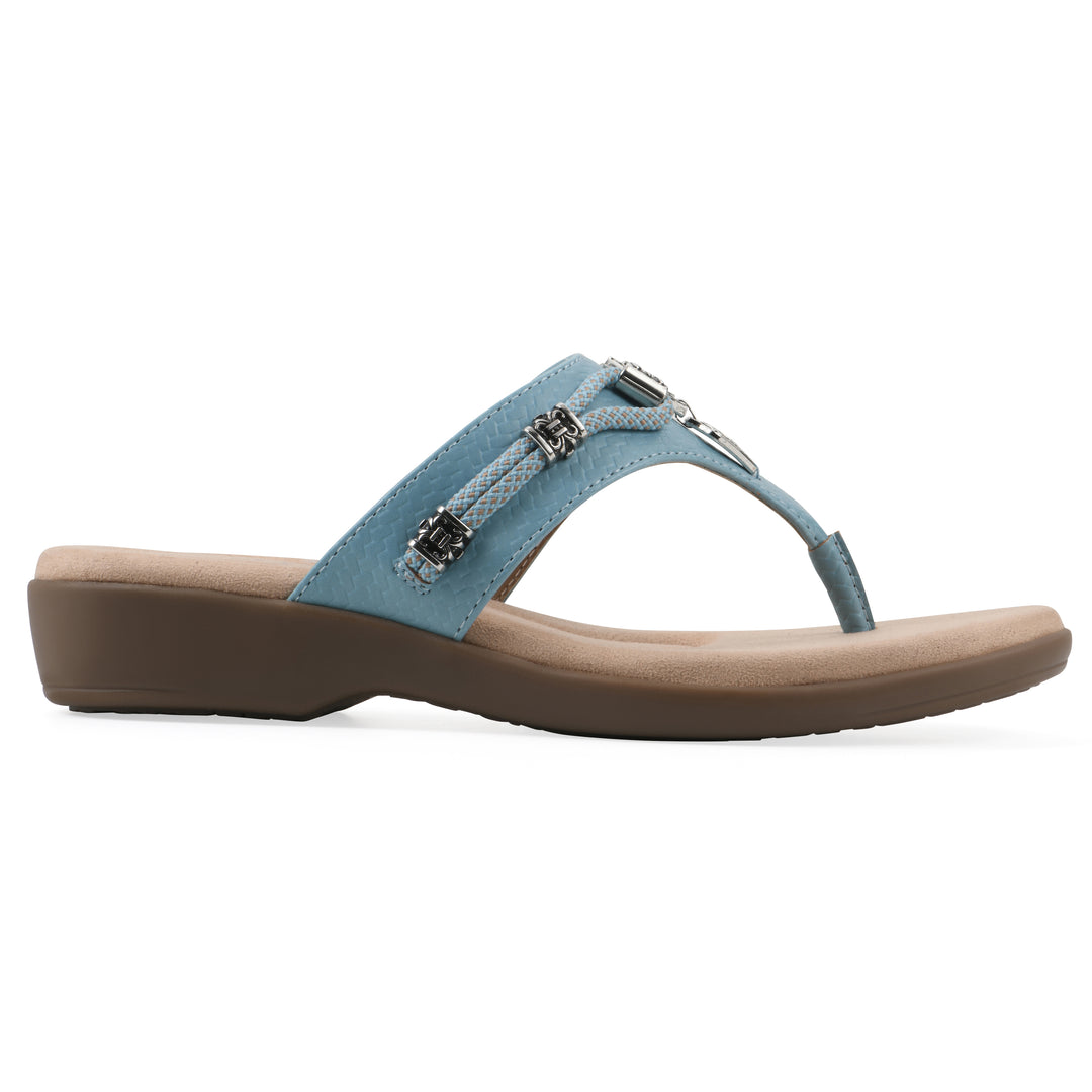 Side view of light blue thong sandal with silver bead embellishments and a tan sole