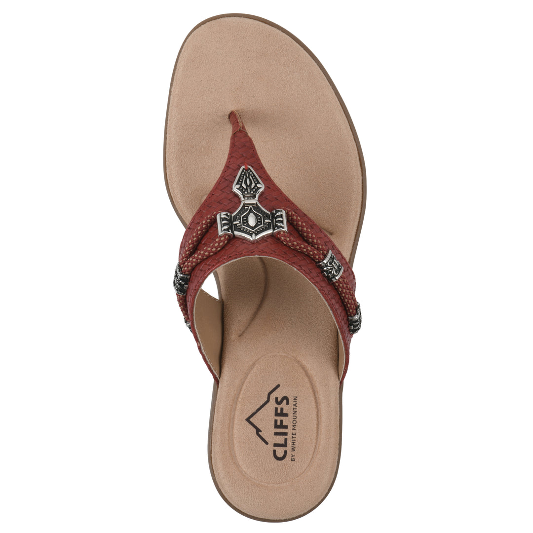 Top view of a brick red thong sandal with silver bead embellishments and a tan sole
