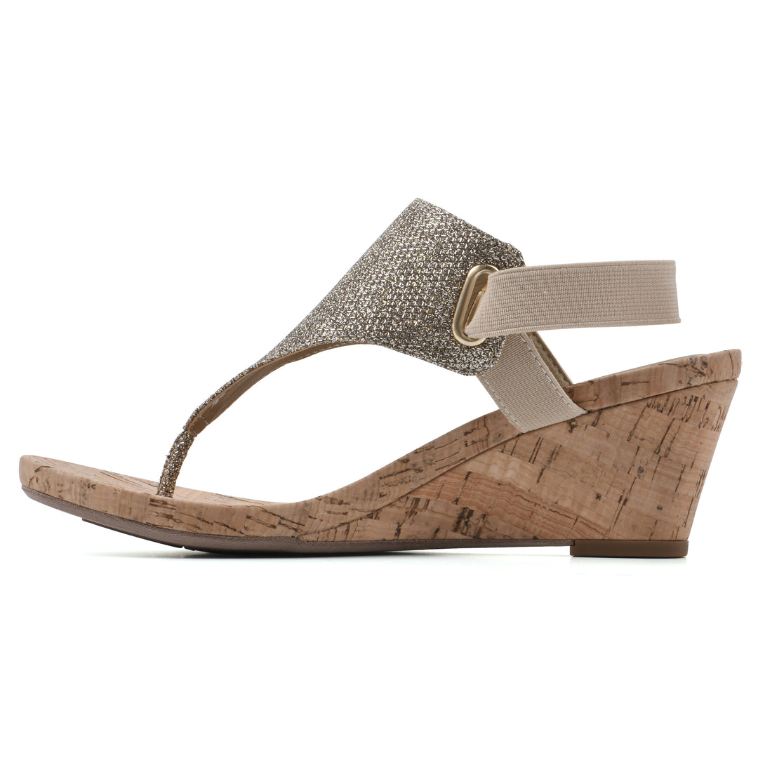Side view of a light gold fabric thong wedge sandal with cork heel, and elastic ankle strap