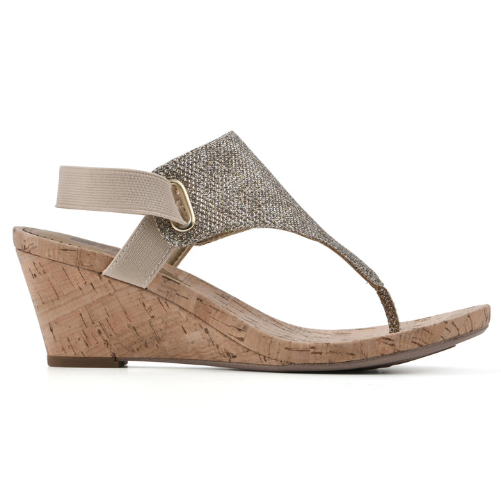 Side view of a light gold fabric thong wedge sandal with cork heel, and elastic ankle strap