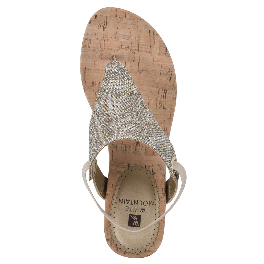 Top view of a light gold fabric thong wedge sandal with cork heel, and elastic ankle strap
