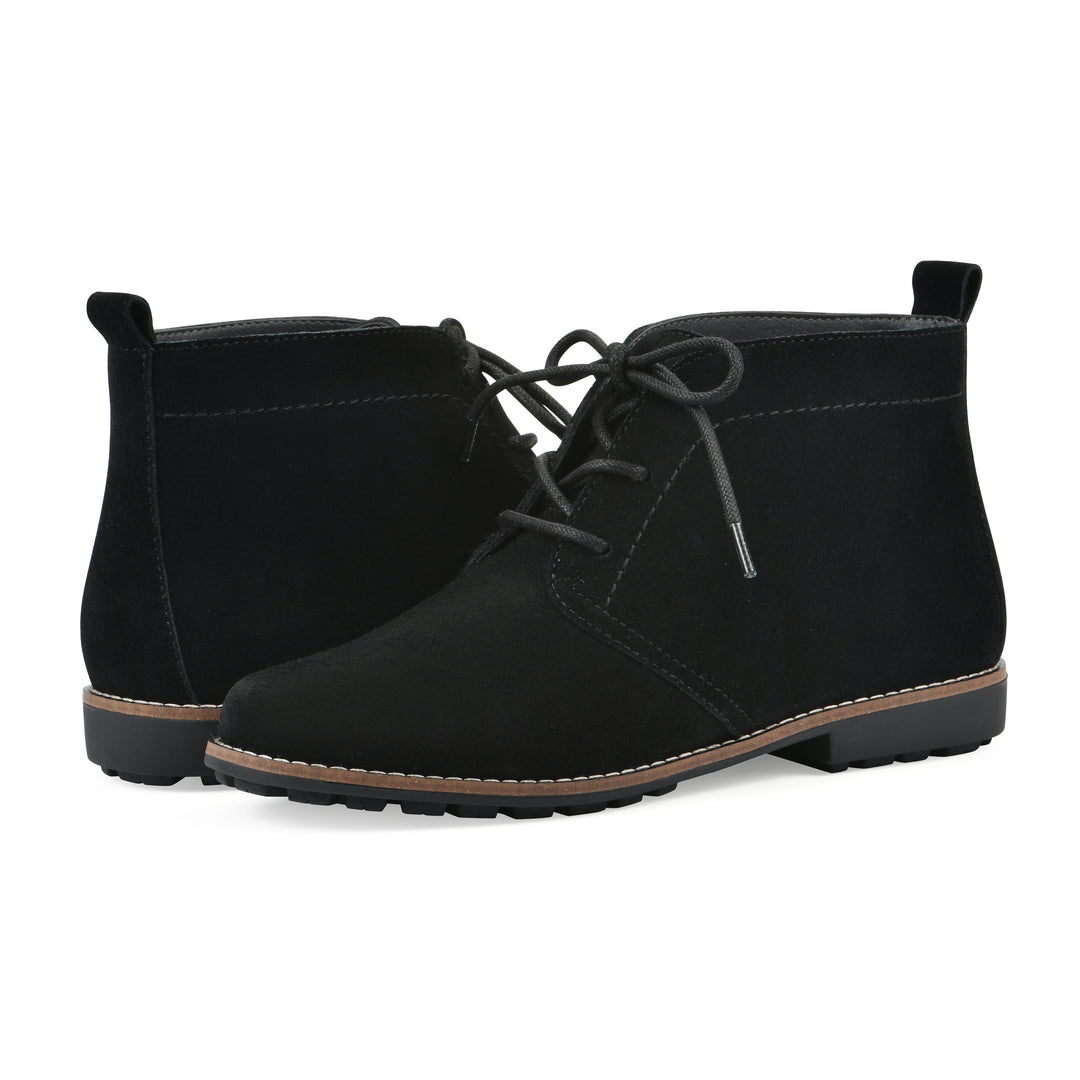 Angle view of a pair of black suede booties with lace-up closure and a low black heel 