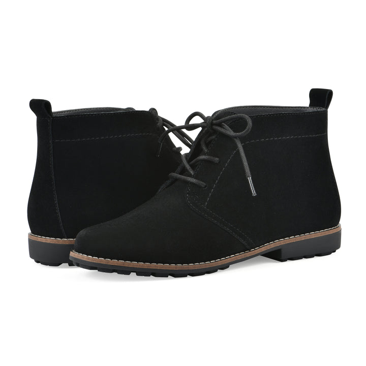 Angle view of a pair of black suede booties with lace-up closure and a low black heel 