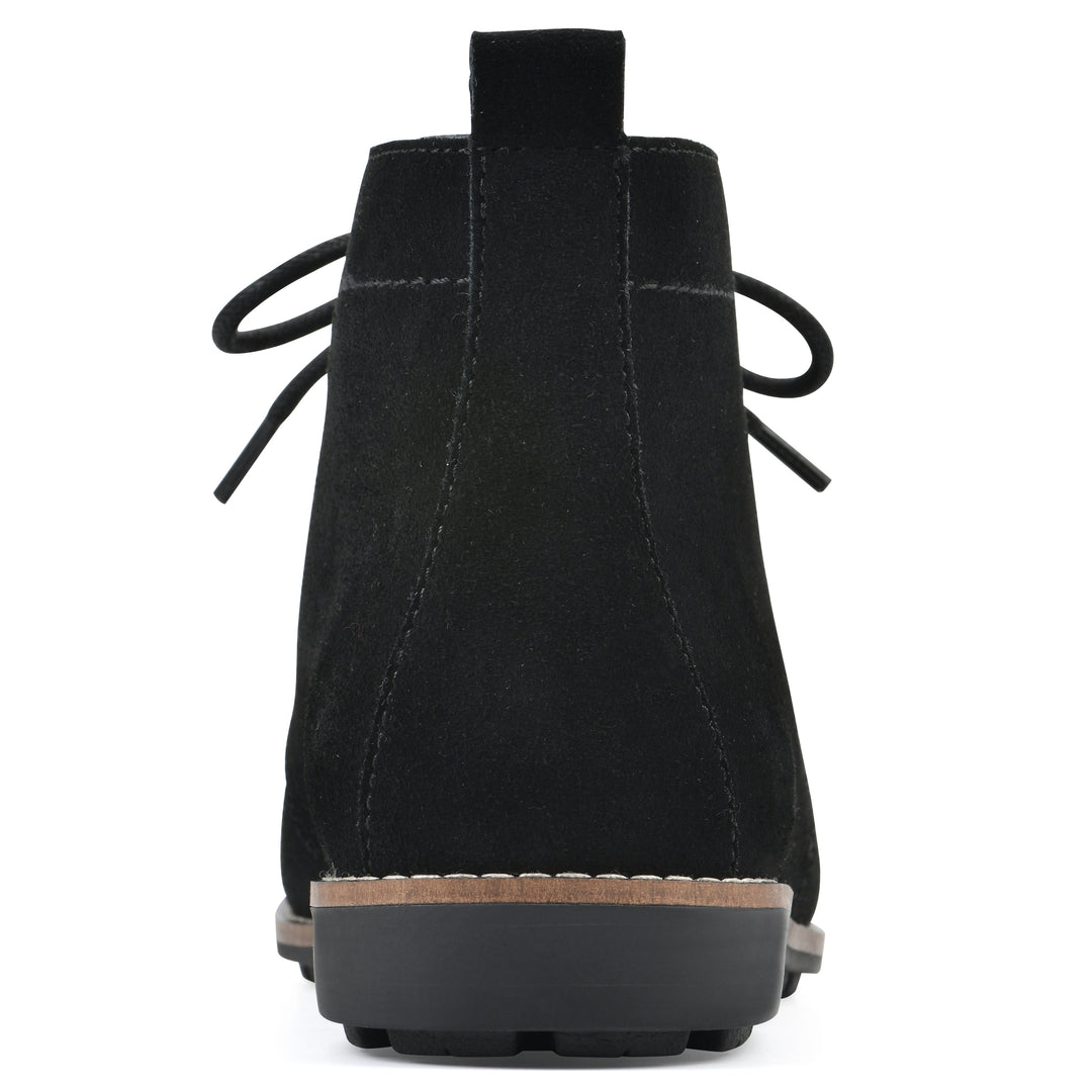 Rear view of a black suede bootie with lace-up closure and a low black heel 
