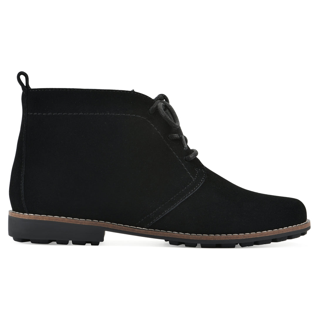 Side view of a black suede bootie with lace-up closure and a low black heel 