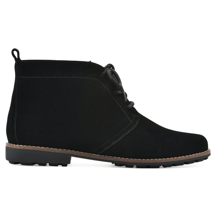 Side view of a black suede bootie with lace-up closure and a low black heel 