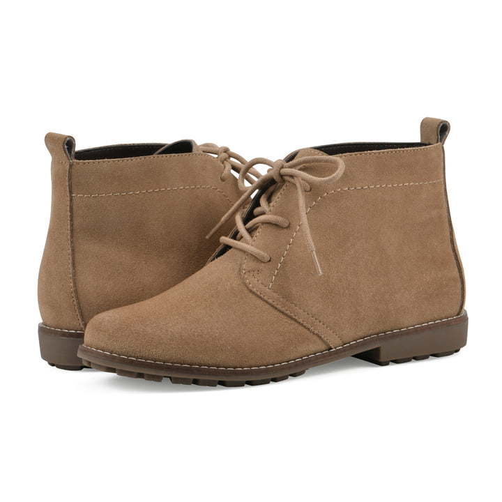 Side view of a pair of tan suede booties with lace-up closure and a low heel 