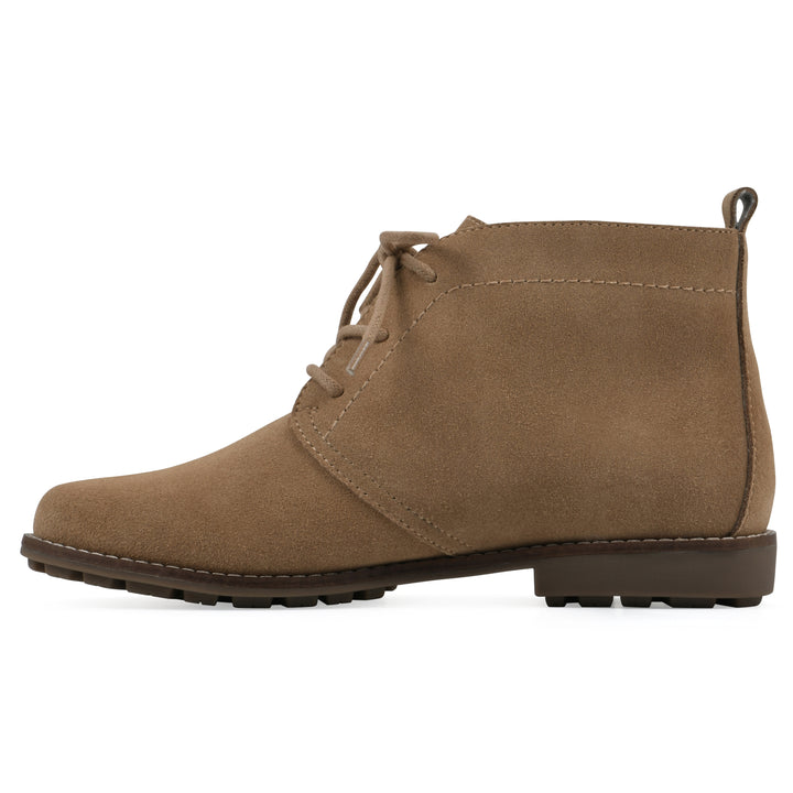 Side view of a tan suede bootie with lace-up closure and a low heel 