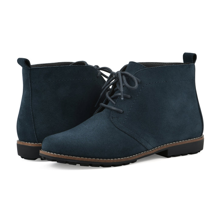 Side view of a  pair of Navy suede booties with lace-up closure and a low heel 