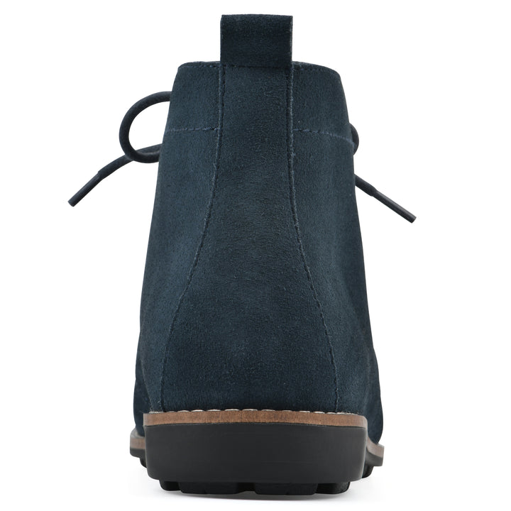 Rear view of a Navy suede bootie with lace-up closure and a low heel 