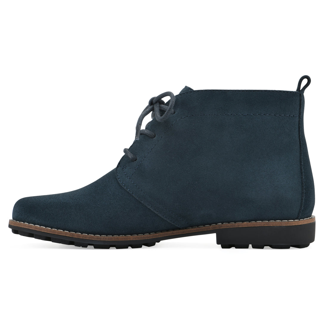 Side view of a Navy suede bootie with lace-up closure and a low heel 
