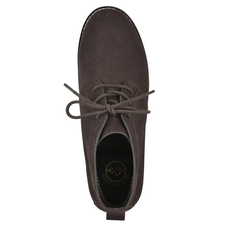 Top view of a deep brown suede bootie with lace-up closure and a low heel 