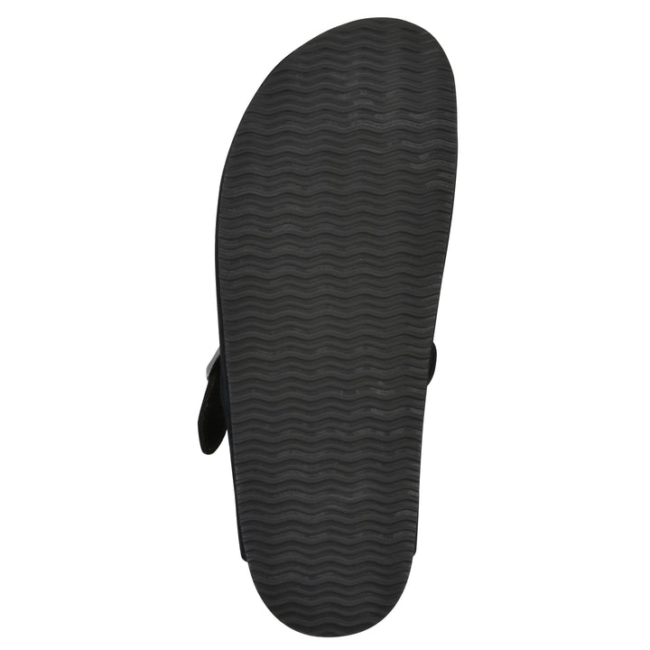 Sole view of a black suede clog with metal buckle on an adjustable strap, and a brown sole with black patterned bottom
