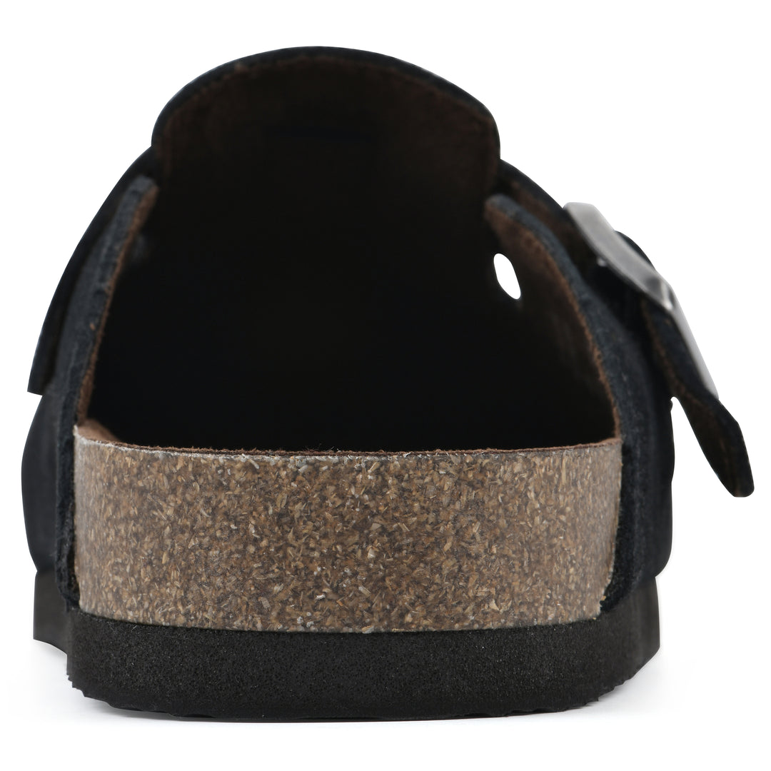 Rear view of a black suede clog with metal buckle on an adjustable strap, and a brown sole with black bottom