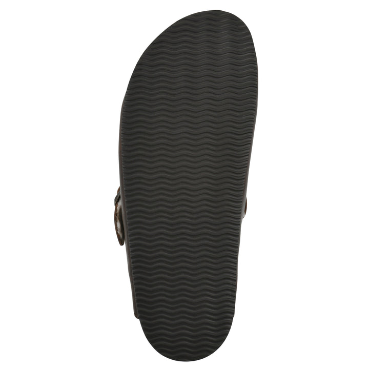 Sole view of a brown leather clog with white faux shearling lining, a metal buckle on an adjustable strap, and a brown sole with black patterned bottom