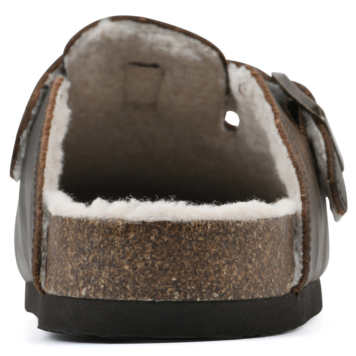 Rear view of a brown leather clog with white faux shearling lining, a metal buckle on an adjustable strap, and a brown sole with black bottom