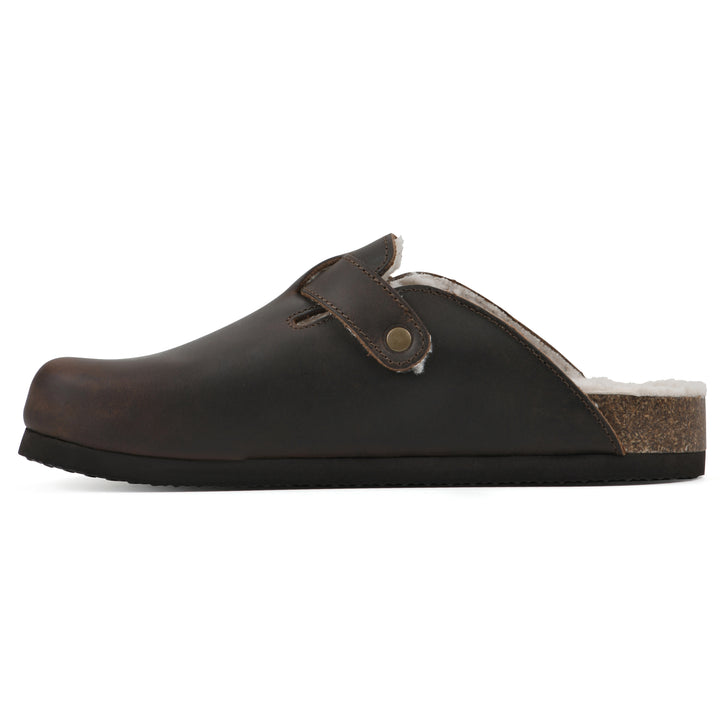 Side view of a brown leather clog with white faux shearling lining, a metal buckle on an adjustable strap, and a brown sole with black bottom