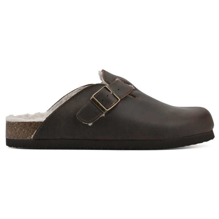 Side view of a brown leather clog with white faux shearling lining, a metal buckle on an adjustable strap, and a brown sole with black bottom