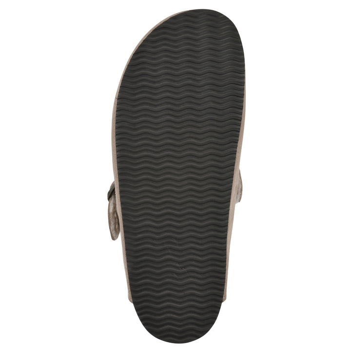 Sole view of a taupe suede clog with white faux shearling lining, a metal buckle on an adjustable strap, and a brown sole with black patterned bottom