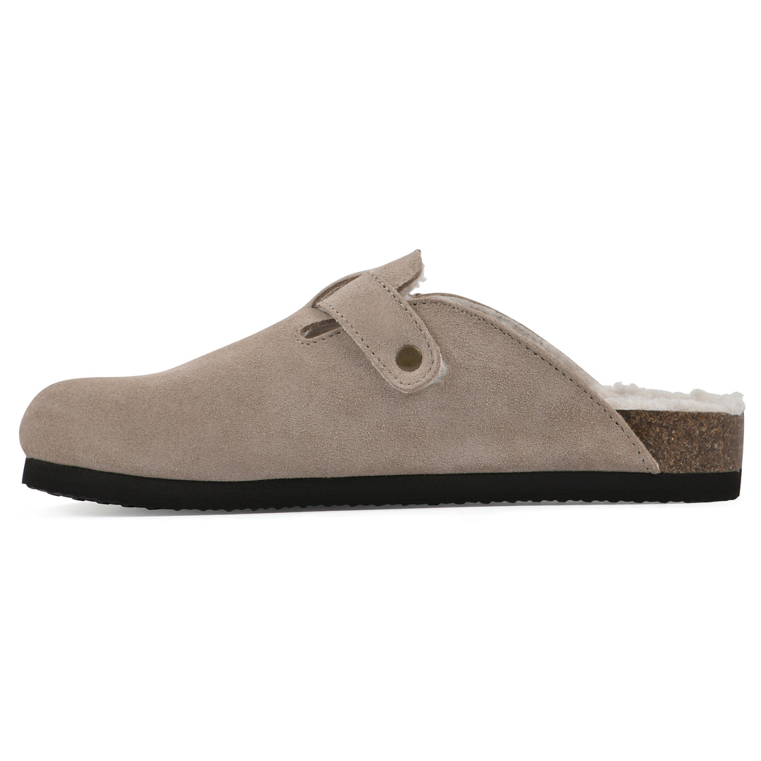 Side view of a taupe suede clog with white faux shearling lining, a metal buckle on an adjustable strap, and a brown sole with black bottom