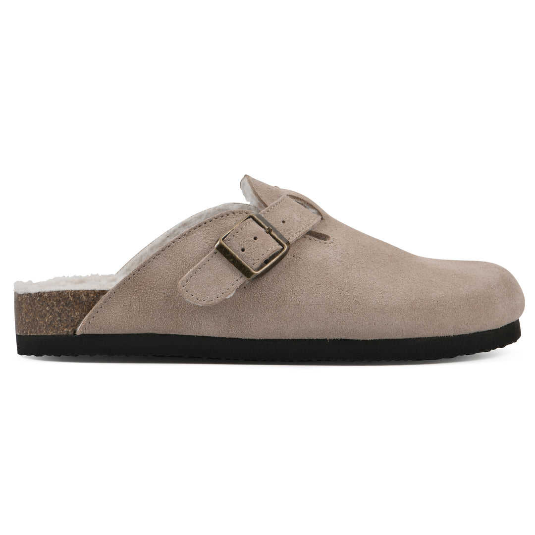 Side view of a taupe suede clog with white faux shearling lining, a metal buckle on an adjustable strap, and a brown sole with black bottom