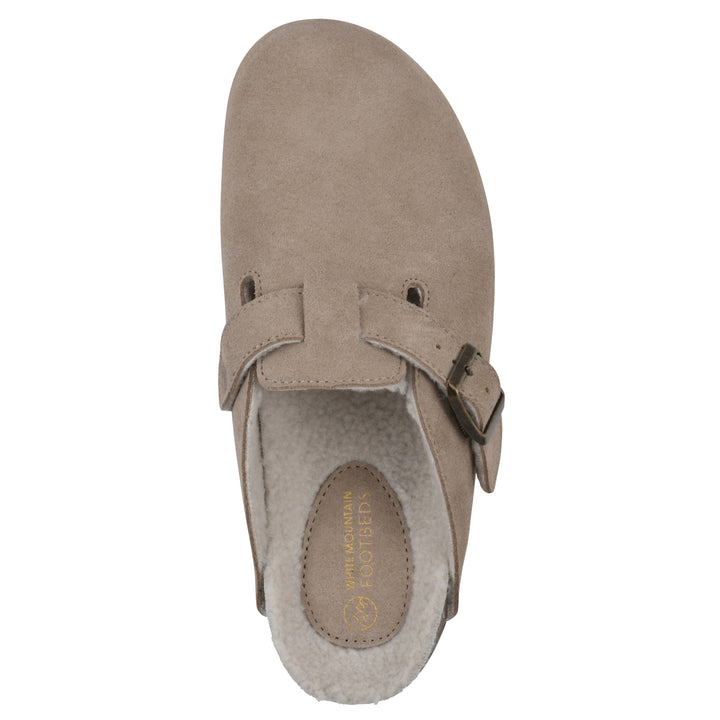 Top view of a taupe suede clog with white faux shearling lining, a metal buckle on an adjustable strap, and a brown sole with black bottom