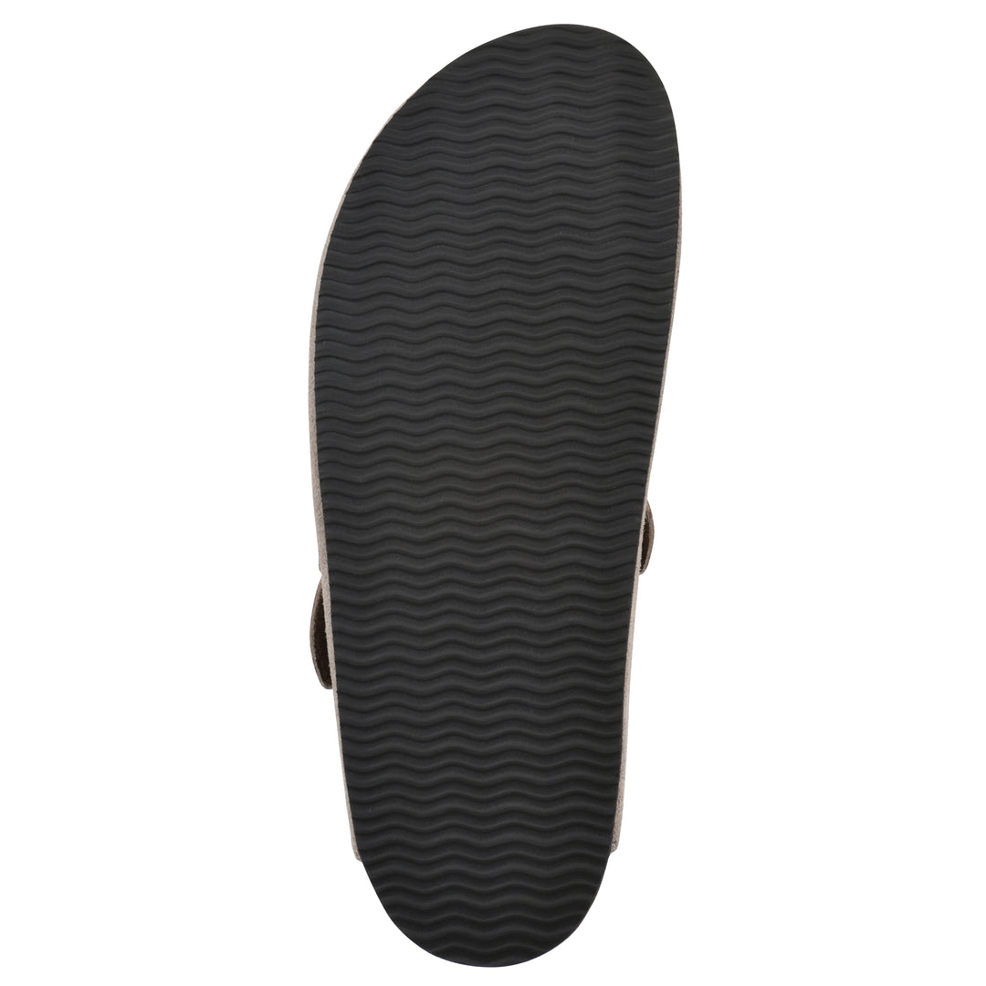 Sole view of a taupe suede clog with metal buckle on an adjustable strap, and a brown sole with black patterned bottom