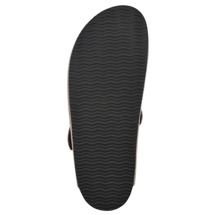 Sole view of a taupe suede clog with metal buckle on an adjustable strap, and a brown sole with black patterned bottom