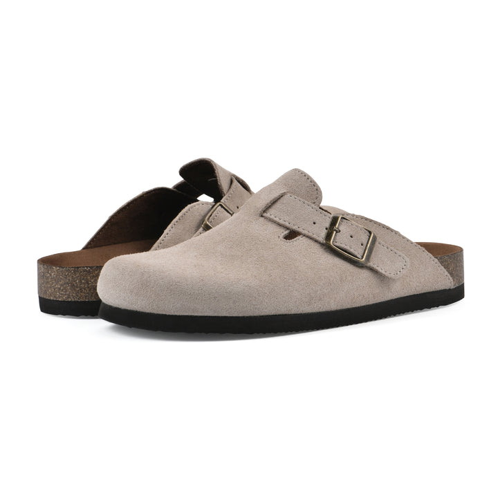 Angle view of a pair of taupe suede clogs with metal buckle on an adjustable strap, and a brown sole with black bottom