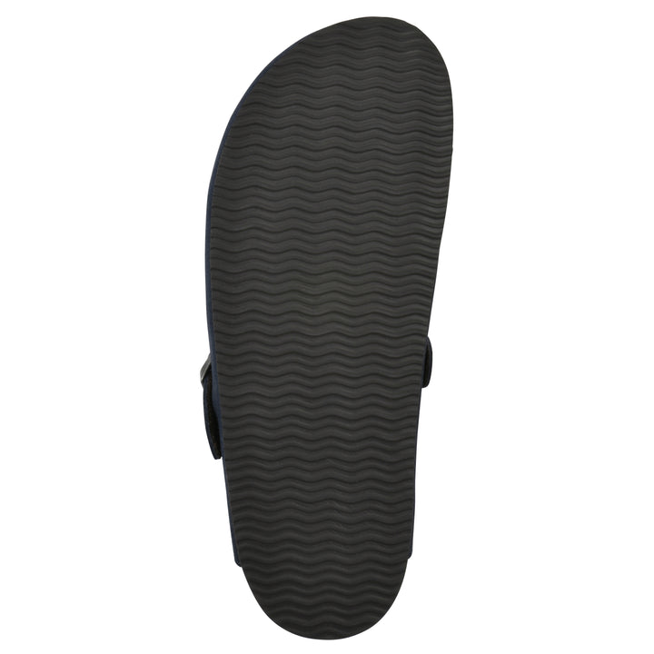 Sole view of a navy suede clog with metal buckle on an adjustable strap, and a brown sole with black patterned bottom