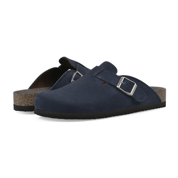 Angle view of a pair of navy suede clogs with metal buckle on an adjustable strap, and a brown sole with black bottom